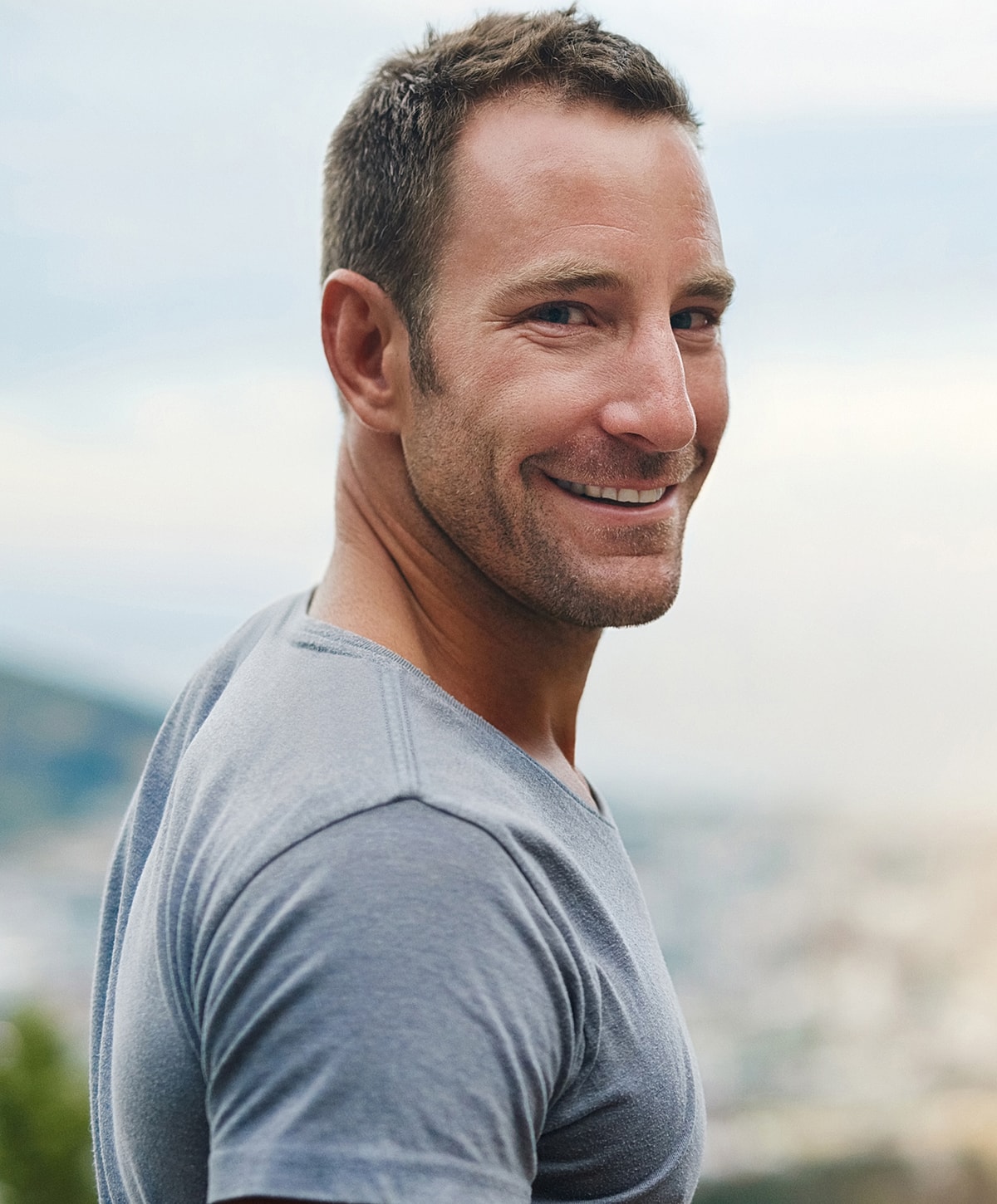 Smiling Torrance IV therapy man outdoors in casual gray shirt.