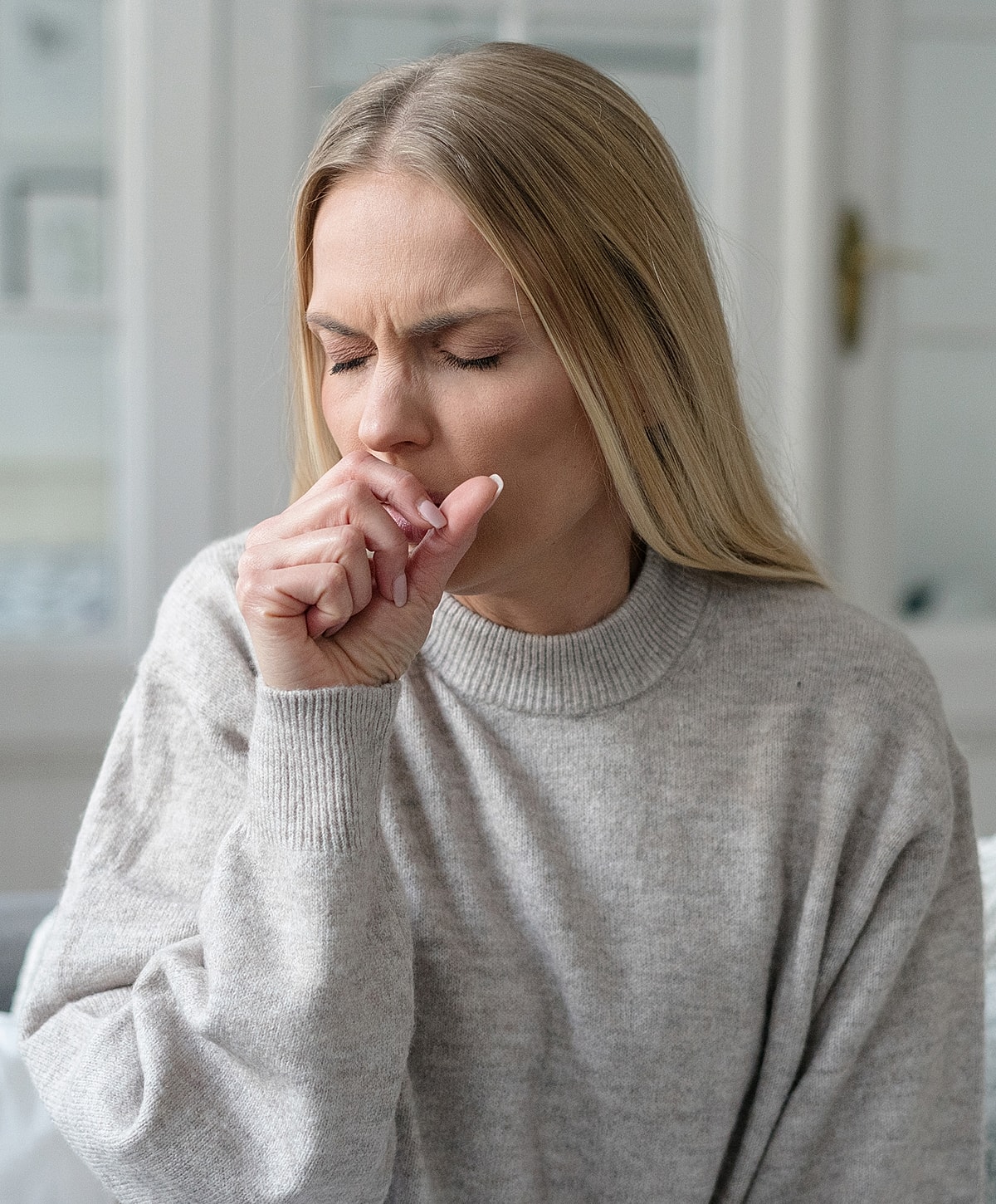 Torrance Long COVID Treatment woman coughing with hand on her mouth.