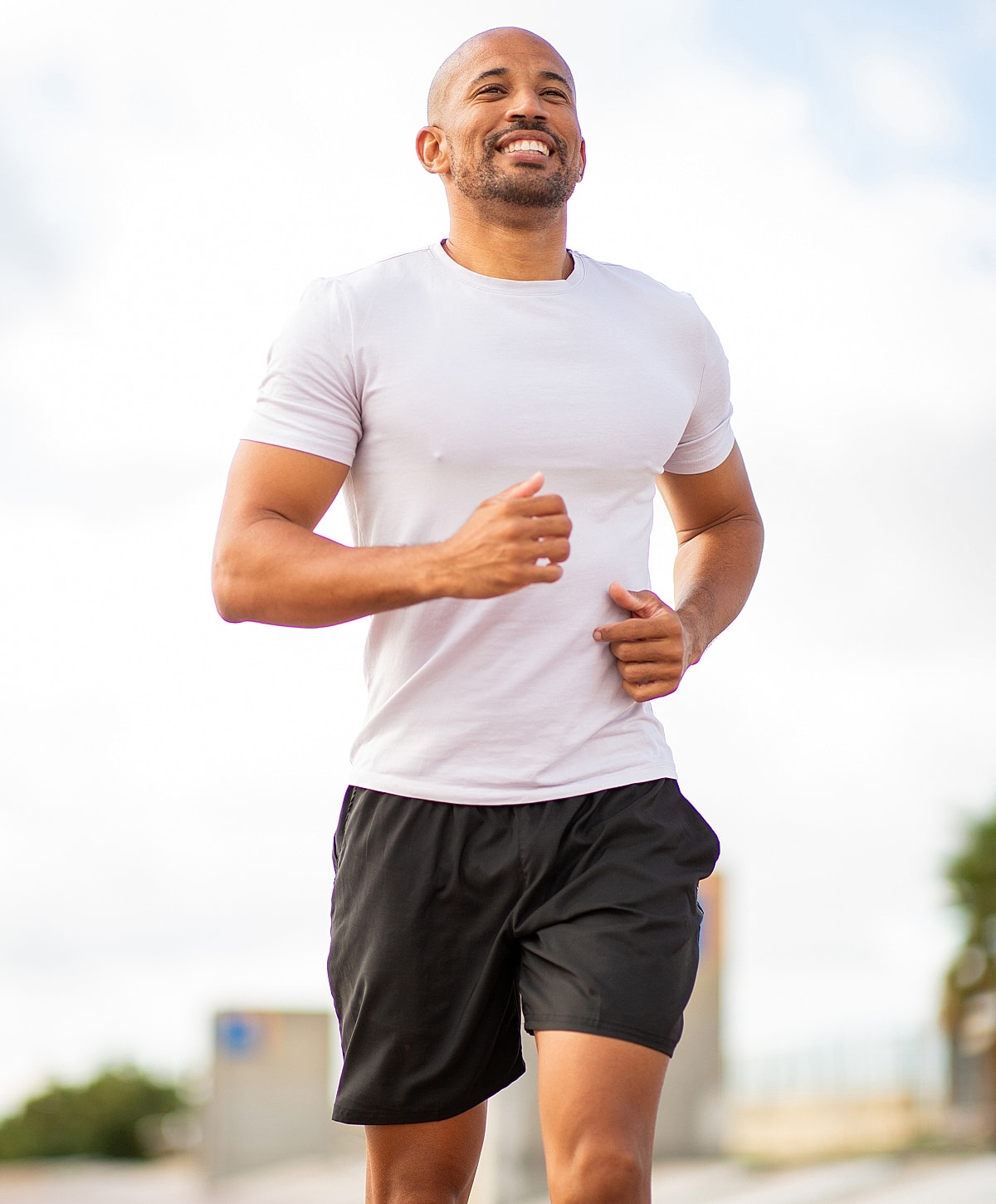 Torrance medical weight loss man jogging outdoors with a smile.