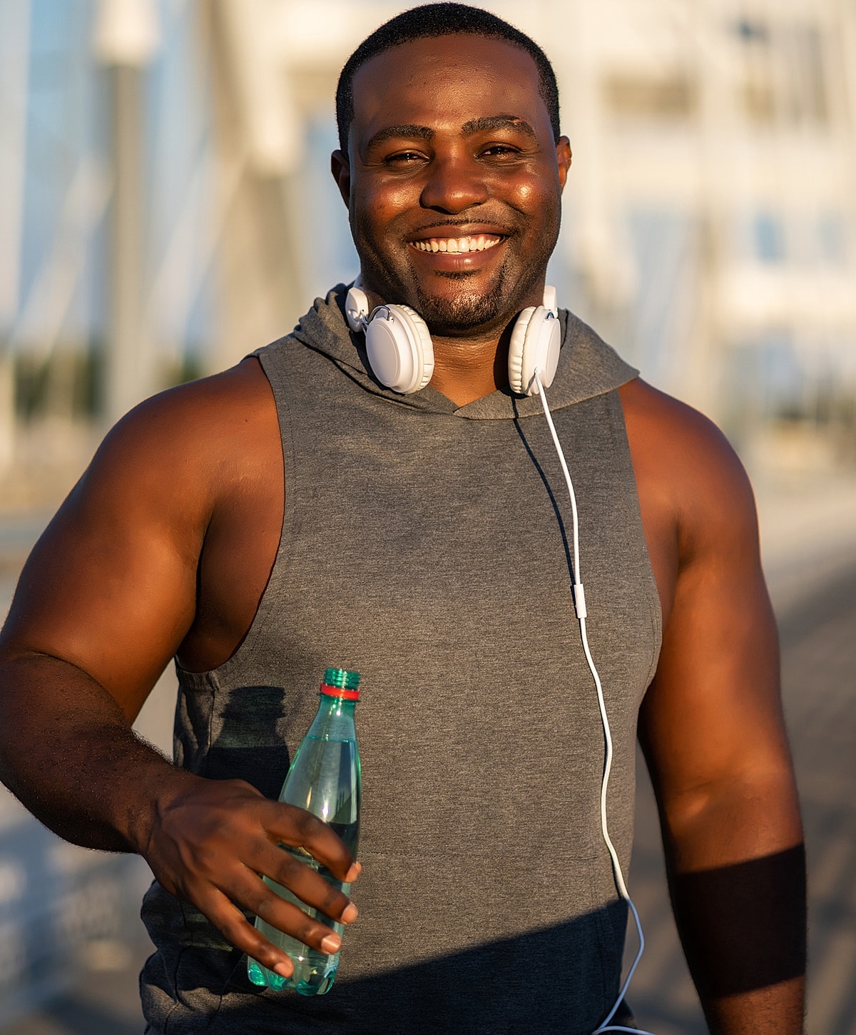 Smiling Torrance obesity treatment man holding a water bottle outdoors.