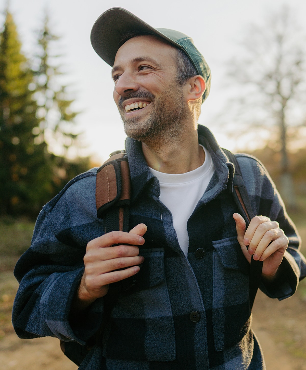 Smiling Torrance POTS treatment man in outdoor setting with backpack.