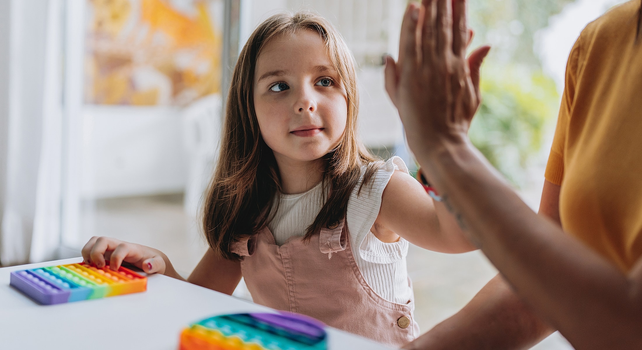 Torrance ASD treatment child playing with colorful sensory toys indoors.