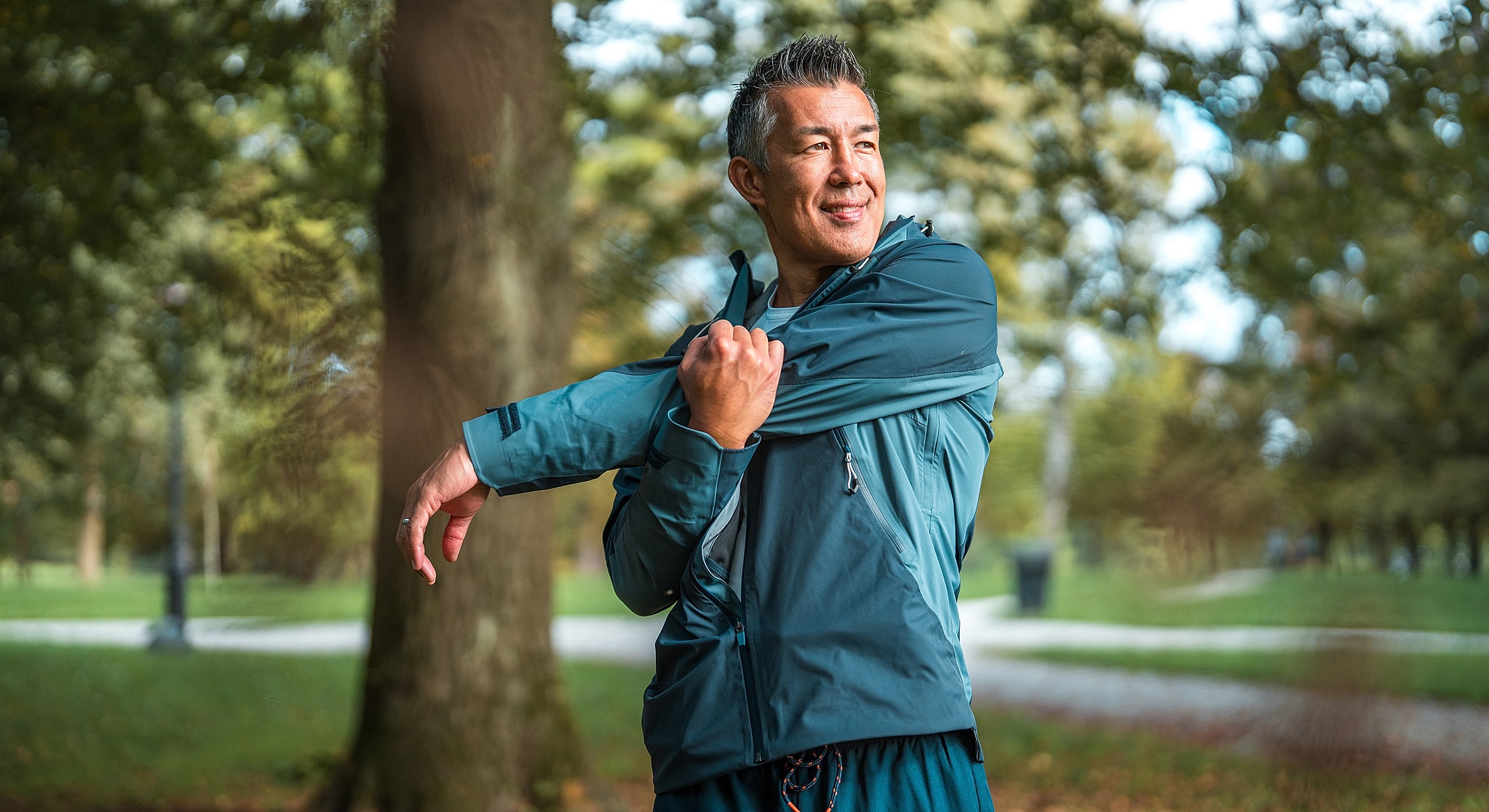 Torrance hEDS treatment man stretching in athletic wear outdoors.