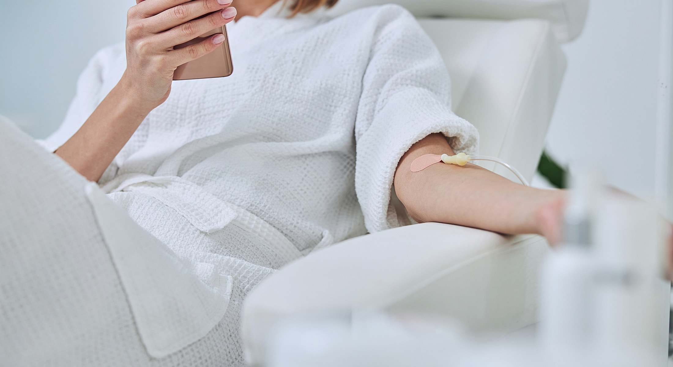 Torrance IV therapy person receiving treatment while using smartphone.