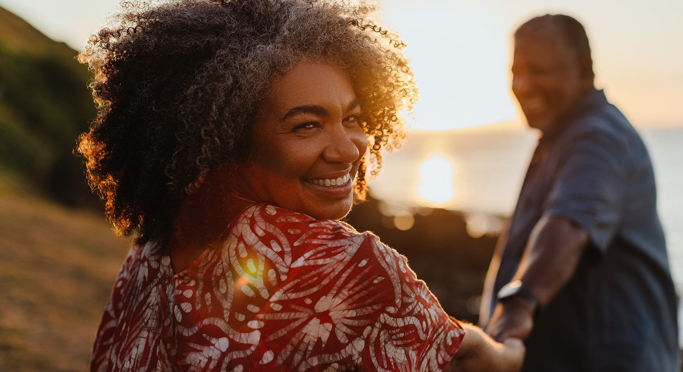 Torrance regenerative medicine couple holding hands at sunset by the beach.
