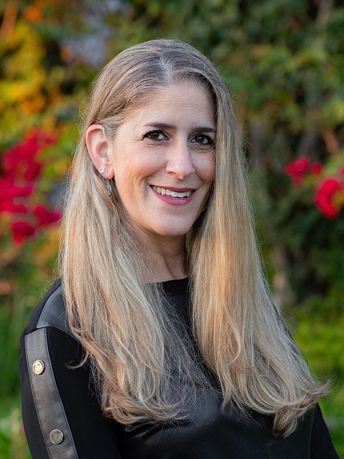 Smiling healthcare professional in white coat.