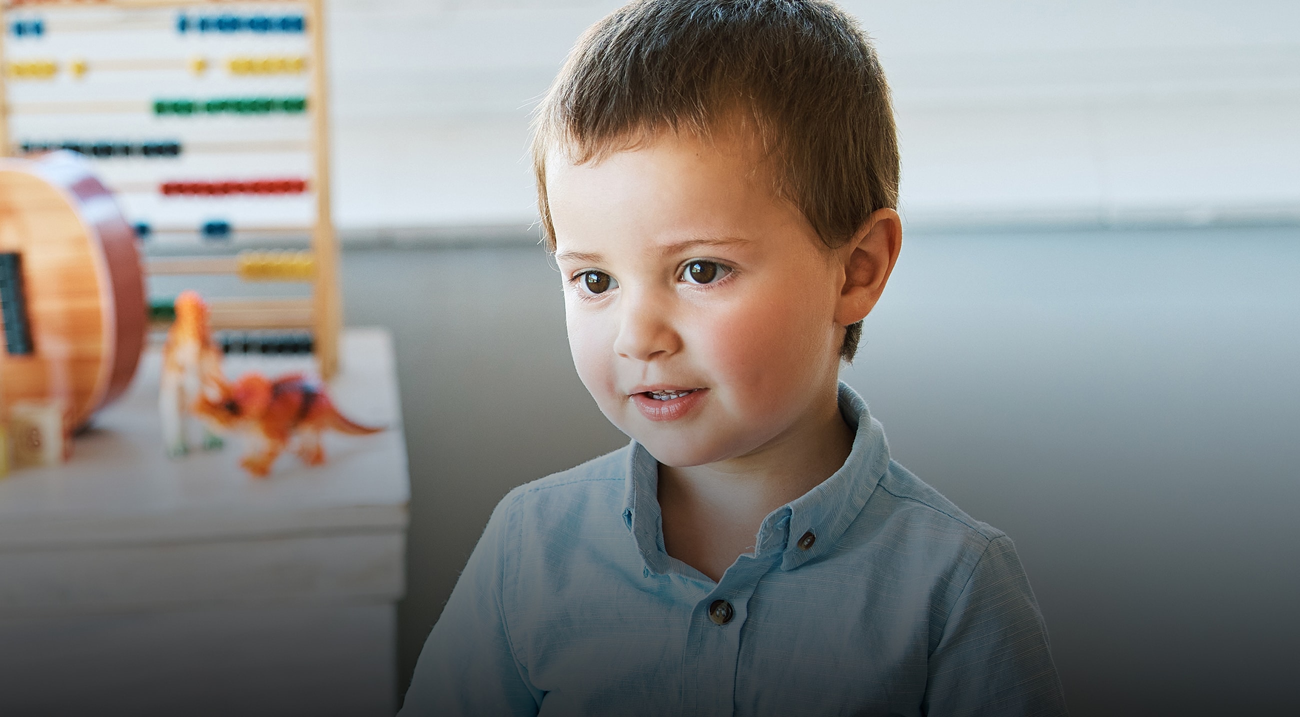 Young boy smiling in a playful environment.